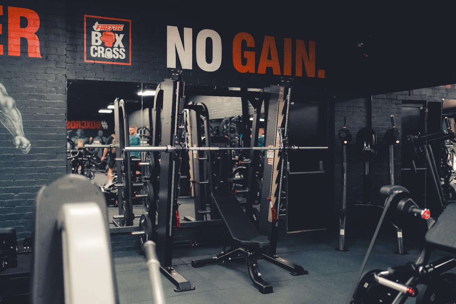 Free weight racks on the main gym floor at Box Cross