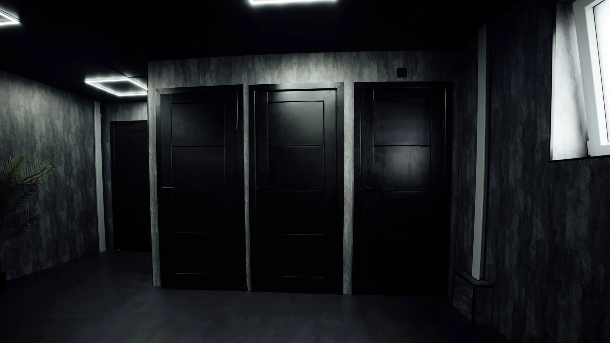 Black cubicle doors along the changing room corridor