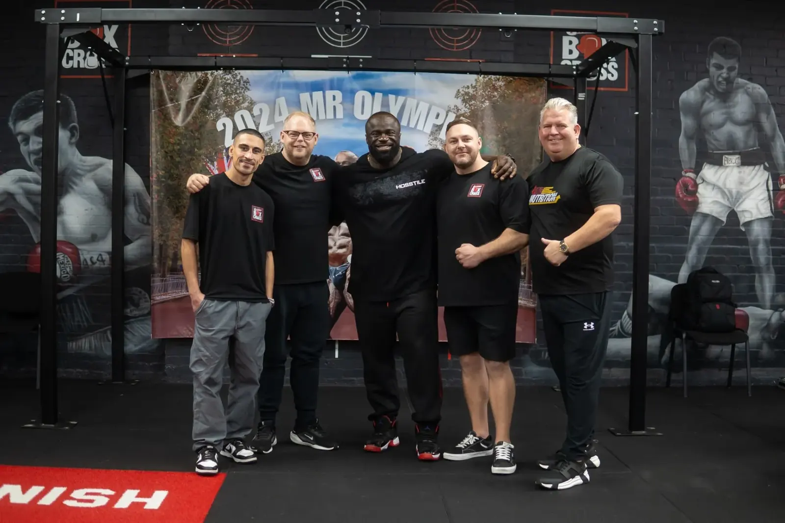 Damien Pearl, Brendan Pearl, Jordan Gill and Gareth Watts, the four founders of BoxCross UK, with Samson Dauda, 2024 Mr Olympia, in the functional room in Wisbech