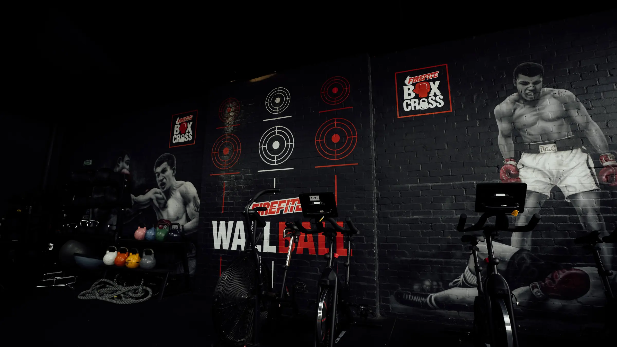 The wall ball target wall with painted targets and an air bike
