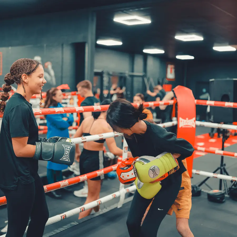 Members laughing together during a women’s and girls’ session in the ring at BoxCross UK