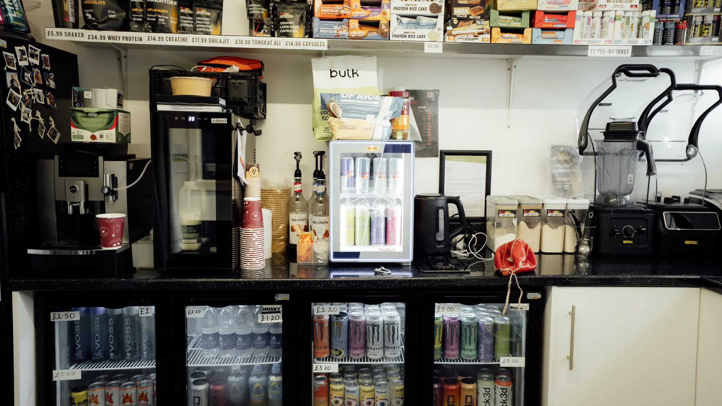 The shop counter with the coffee machine and drinks fridge