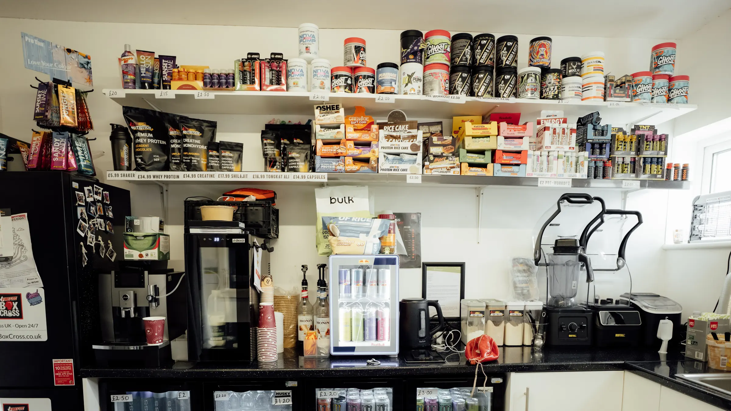 Shelves of supplements and the coffee machine in the BoxCross shop